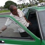 Driver entering Nissan Cedric taxi in Fiji Driver entering Nissan Cedric taxi in Fiji