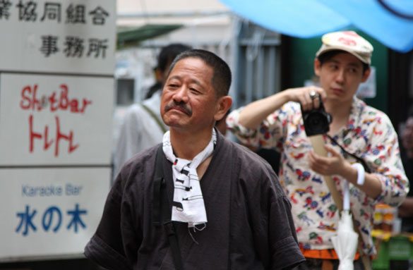 Yusuke Hama performs during a festival at the entrance to the Golden Gai entertainment area of Tokyo's Shinjuku Ward. Yusuke Hama performs during a festival at the entrance to the Golden Gai entertainment area of Tokyo's Shinjuku Ward.
