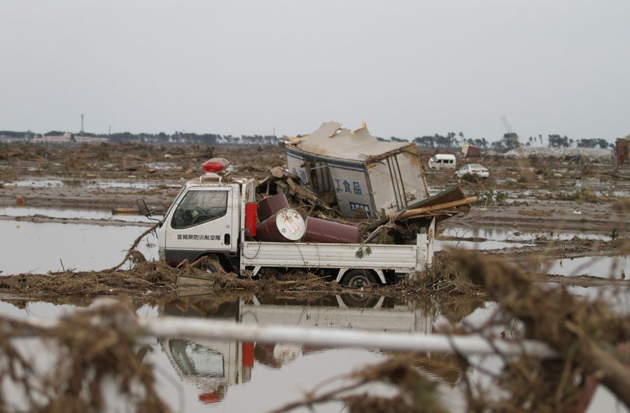 A truck moved by the tsunami sits in a field in Wakabayashi Ward A truck moved by the tsunami sits in a field in Wakabayashi Ward