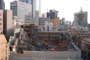 View of TSK.CCC building during demolition in 2008 with Roppongi Hills in background