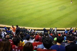 Fans in the stands in left field