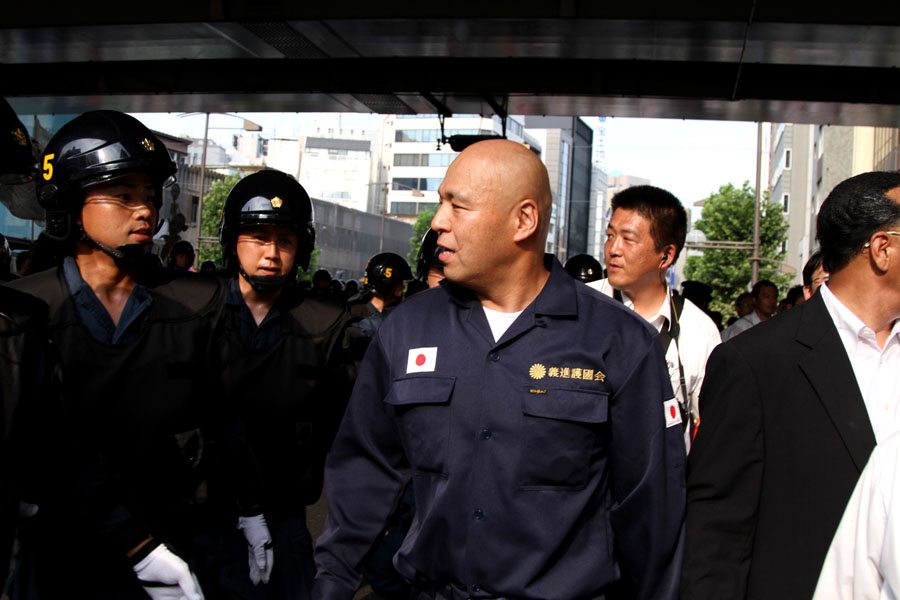 Shinichi Kamijo of right-wing group Gishin Gokoku-kai at a left-wing protest near Yasukuni Shrine