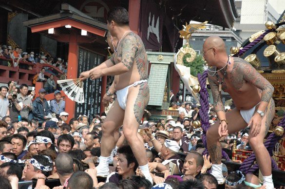 Members of the Asakusa Takahashi-gumi atop a mikoshi at the Sanja Matsuri