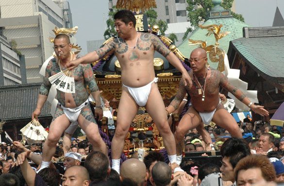 Members of the Asakusa Takahashi-gumi atop a mikoshi at the Sanja Matsuri