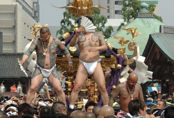 aMembers of the Asakusa Takahashi-gumi atop a mikoshi at the Sanja Matsuri