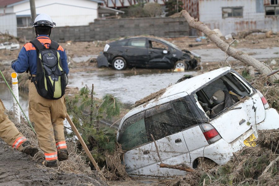 A rescue worker at the edge of a field in Wakabayashi Ward