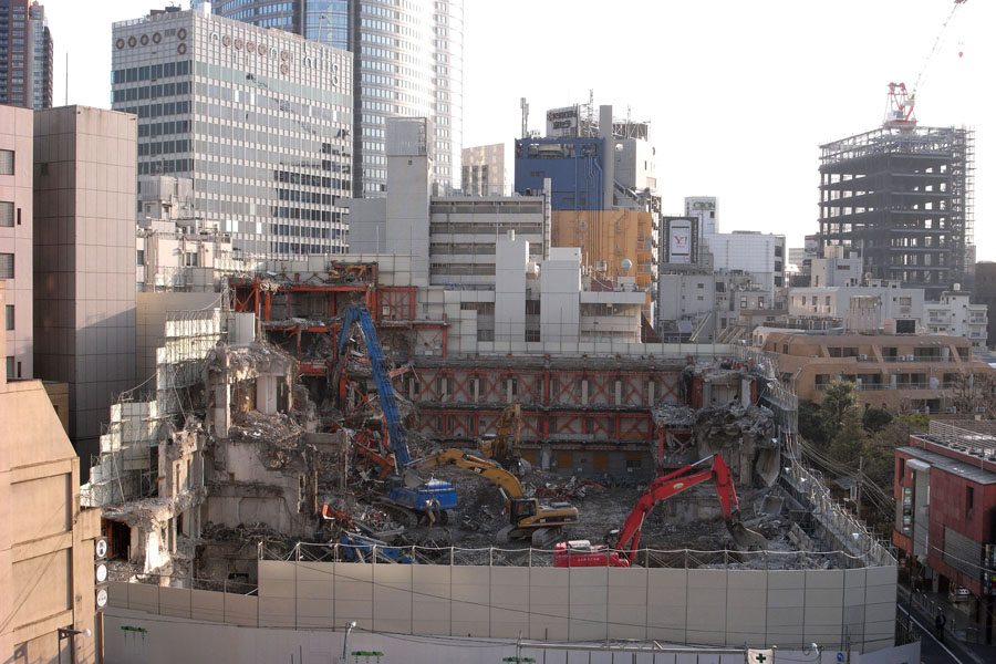 View of TSK.CCC building during demolition in 2008 with Roppongi Hills in background