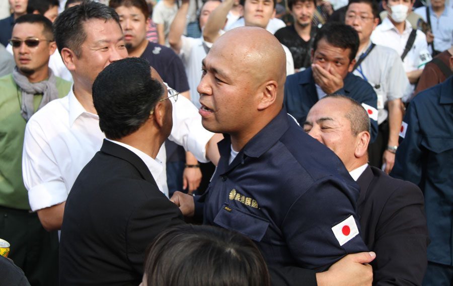 Shinichi Kamijo of right-wing group Gishin Gokoku-kai at a left-wing protest near Yasukuni Shrine in Tokyo's Chiyoda Ward