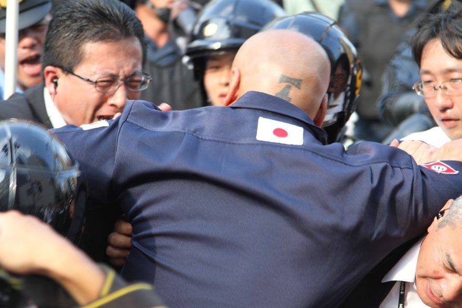Shinichi Kamijo of right-wing group Gishin Gokoku-kai at a left-wing protest near Yasukuni Shrine in Tokyo's Chiyoda Ward