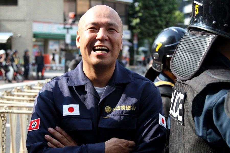Shinichi Kamijo of right-wing group Gishin Gokoku-kai at a left-wing protest near Yasukuni Shrine in Tokyo's Chiyoda Ward