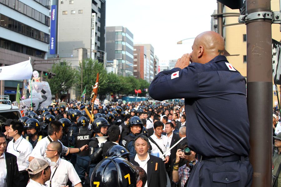 Shinichi Kamijo of right-wing group Gishin Gokoku-kai at a left-wing protest near Yasukuni Shrine in Tokyo's Chiyoda Ward