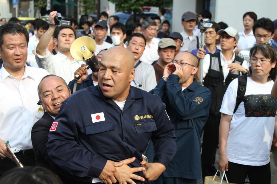 Shinichi Kamijo of right-wing group Gishin Gokoku-kai at a left-wing protest near Yasukuni Shrine in Tokyo's Chiyoda Ward