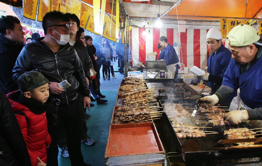 Vendor selling grilled beef and pork