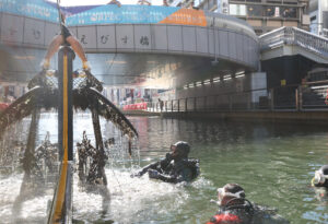 Divers haul sunken bicycles, wallets from murky depths of Osaka's Dotonbori River