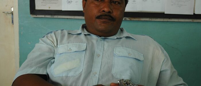 A policeman holds handcuffs at his station in Funafuti