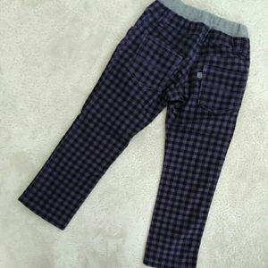 A body clothed in black checkered pants