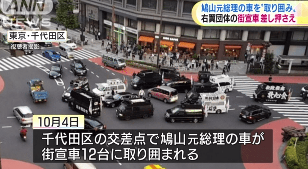 Trucks from the Somokukki no Kai surround ex-PM Hatoyama's car