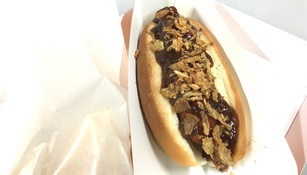 A barbecue dog slathered in a mild, smoke-tinged sauce