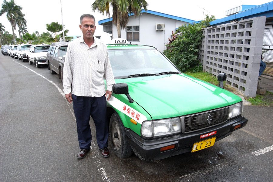 A driver with a Nissan Cedric taxi in Fiji