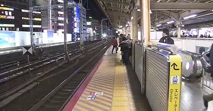 A German woman suffered minor injuries after a man pushed her into an oncoming train on a platform in Kobe on Tuesday