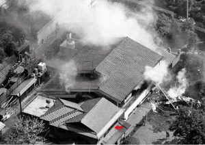 The residence of Yoshio Kodama after the attack with a red arrow showing where he was when the plane struck