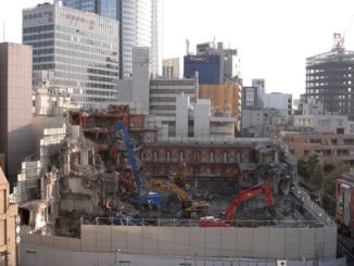 TSK.CCC during demolition with Roppongi Hills in background" width="900" height="600" /> The TSK.CCC building is seen during demolition with Roppongi Hills in the background